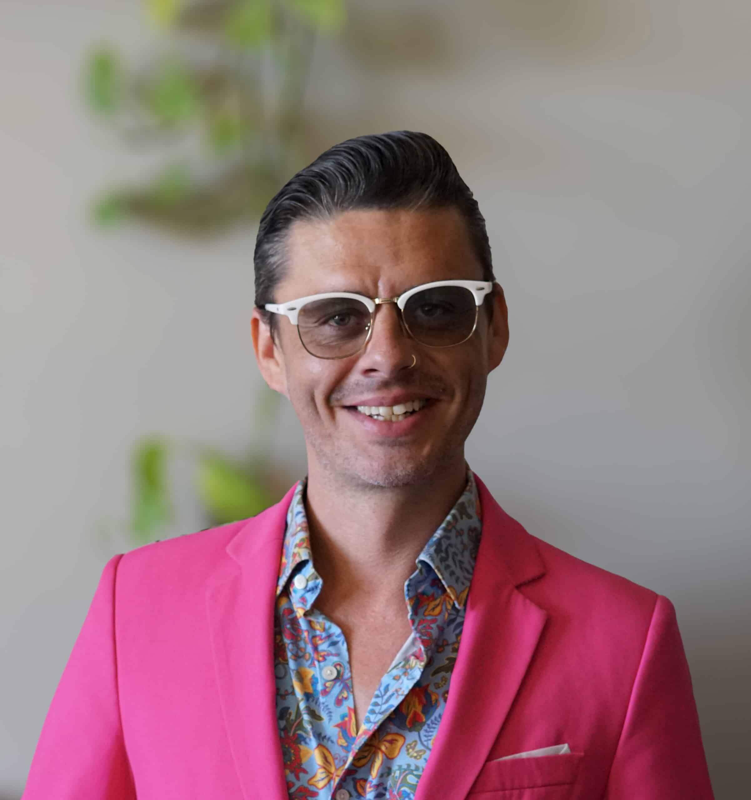 photo of Rustic Canyon's General Manager smiling in a bright pink blazer and a colorful button up