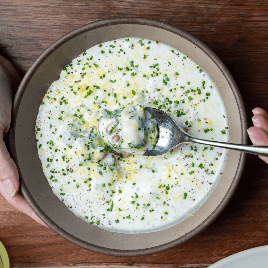 A spoon lifting out some Farmers Cheese Gnocchi out of a bowl